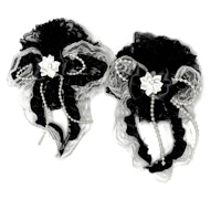 a pair of black and white hair clips with pearls