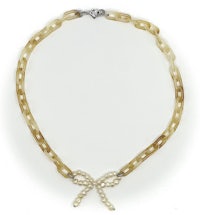 a necklace with a bow and pearls on it