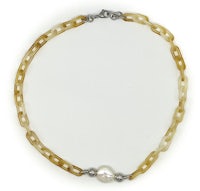 a necklace with a yellow pearl and a chain